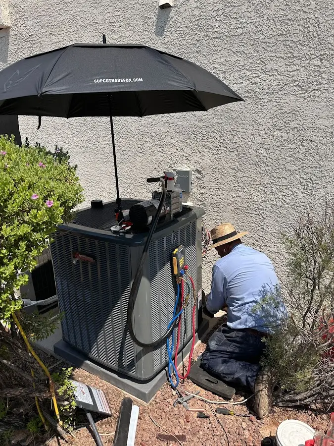 HVAC technician performing outdoor AC maintenance in Wilsonville